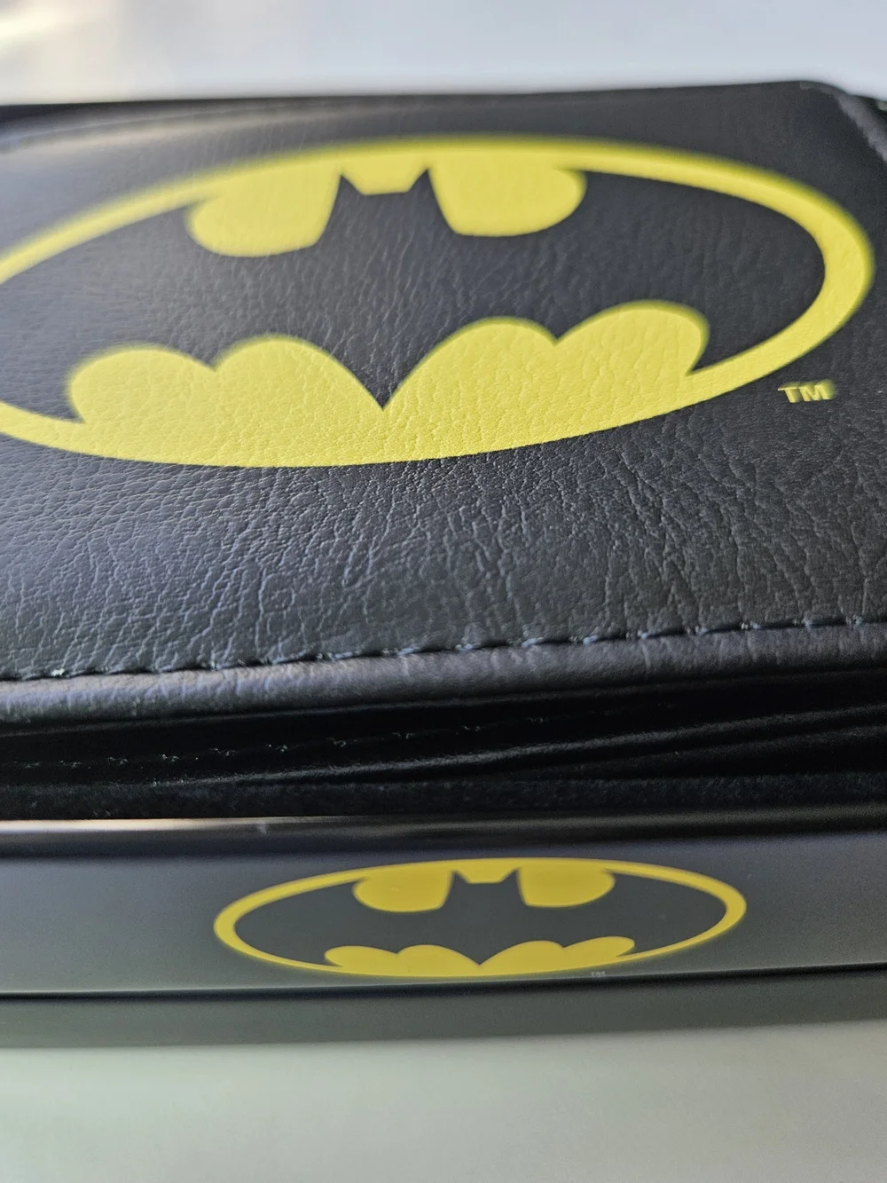 officially licensed DC Comics Batman Bifold Wallet resting inside its protective